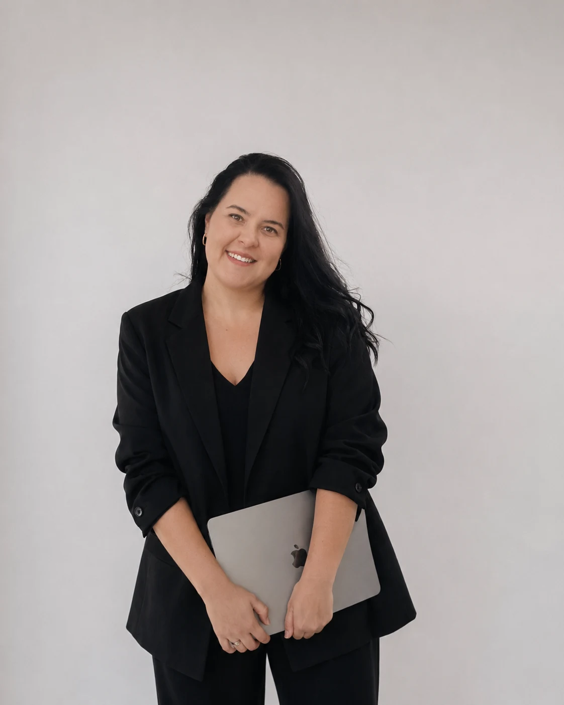 Maxine, founder of Cultish, holding her laptop
