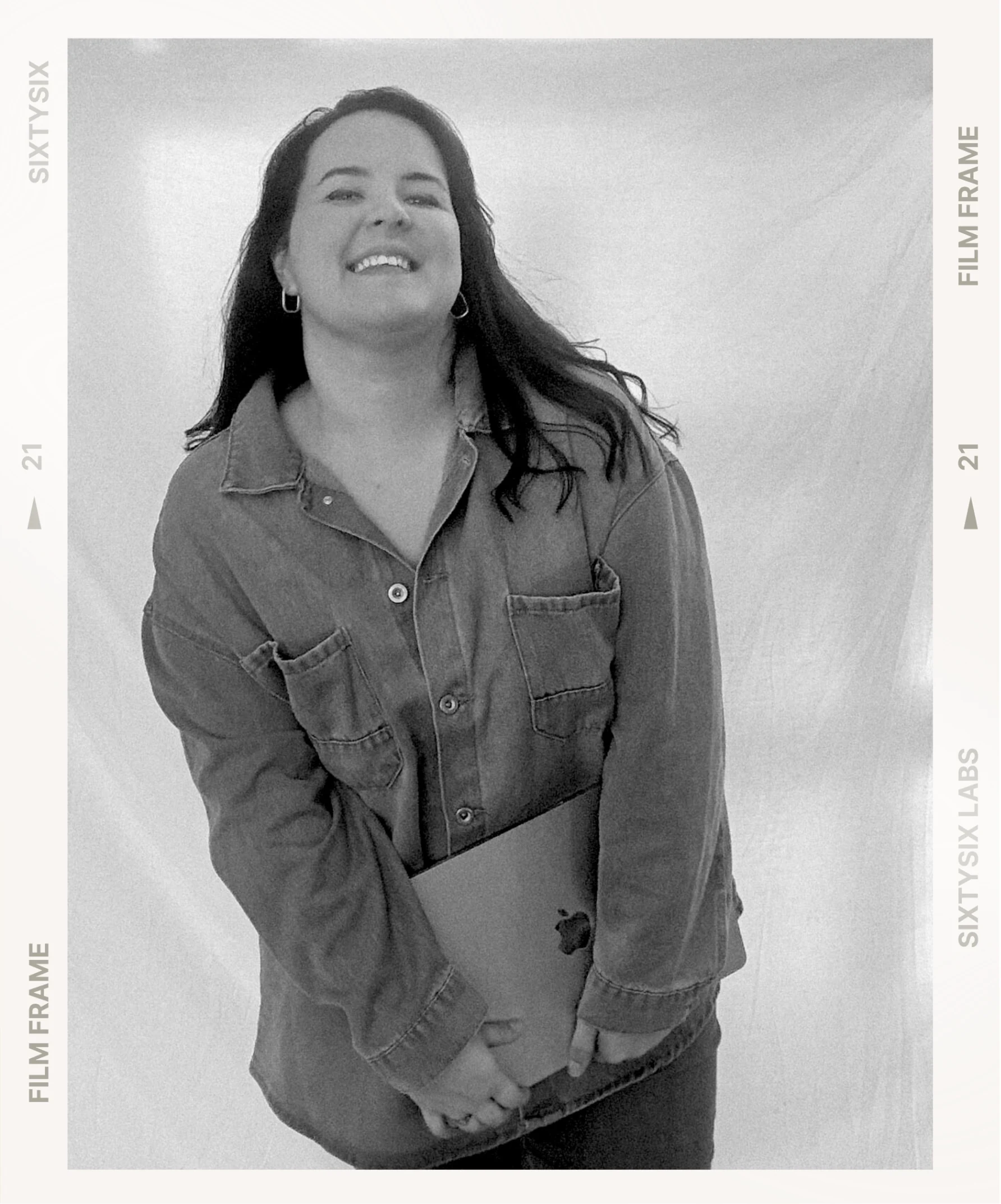 Maxine, founder and creative director of Cultish, laughing while holding her laptop