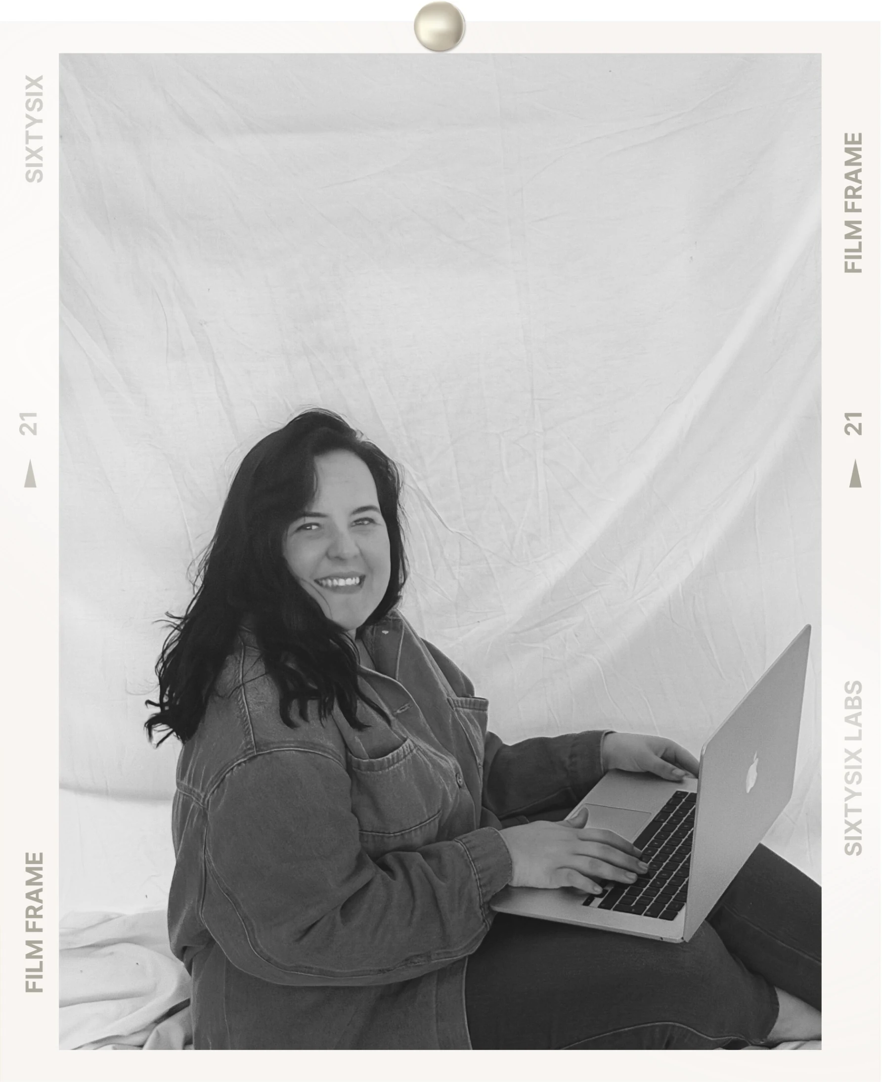 Maxine working on her laptop in her studio
