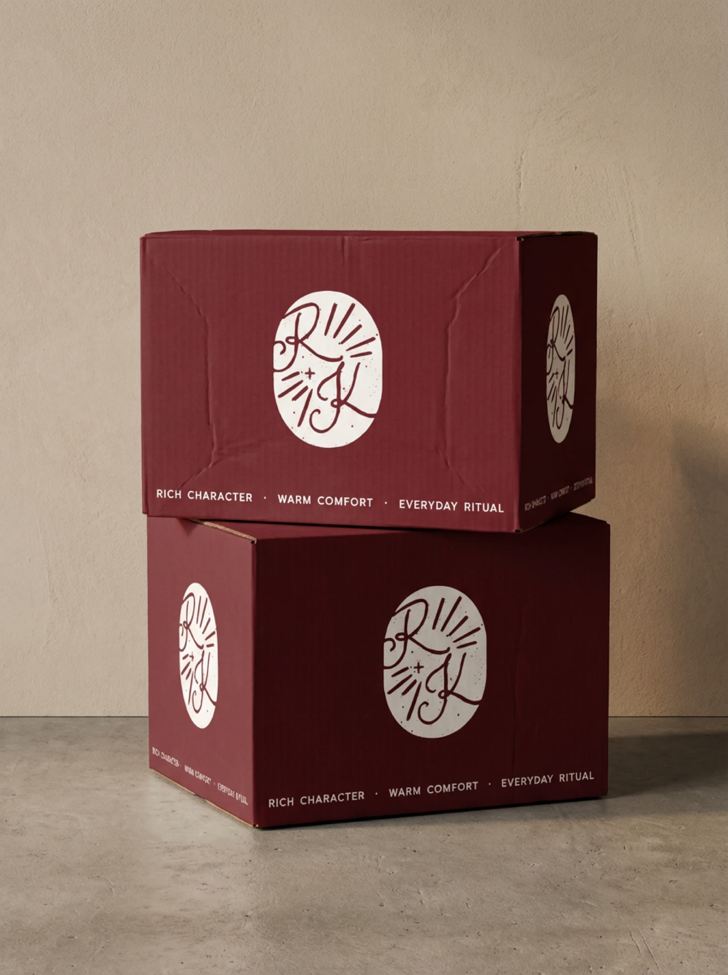 Root and Kin stacked burgundy shipping boxes