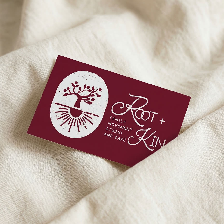 Root and Kin burgundy business card on natural linen